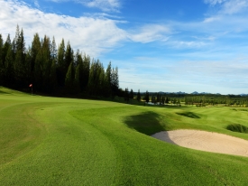 Golf course fairway with blue sky.