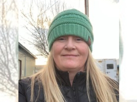 Portrait of woman with long blonde hair and green beanie 