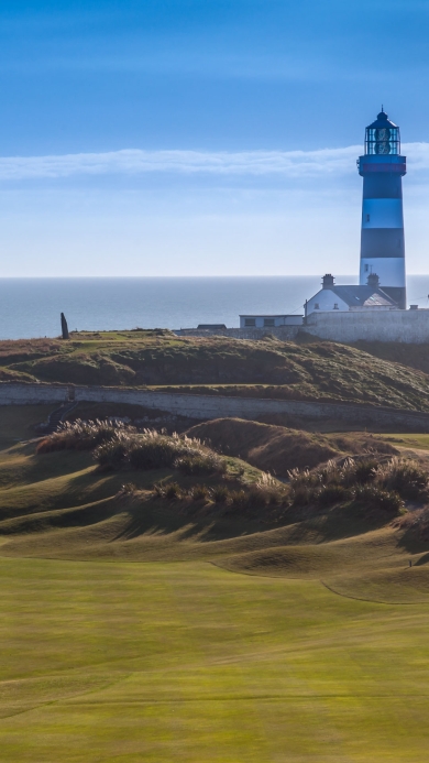 Lighthouse on golf course on the coast.