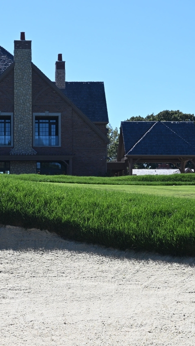Golf course bunker with dark green grass