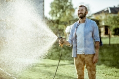 man watering lawn