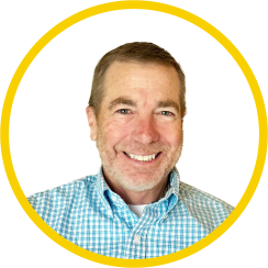 Professional headshot of a man with a yellow ring around the photo 