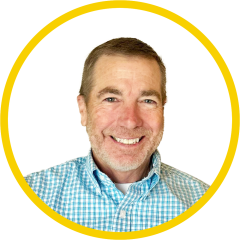 Professional headshot of a man with a yellow ring around the photo 
